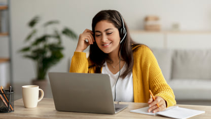 Woman wearing a headset while in a virtual setting.