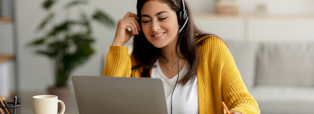 Woman wearing a headset while in a virtual meeting.